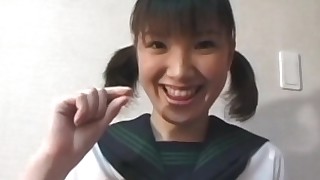 Pigtailed Japanese chick plays with her puss